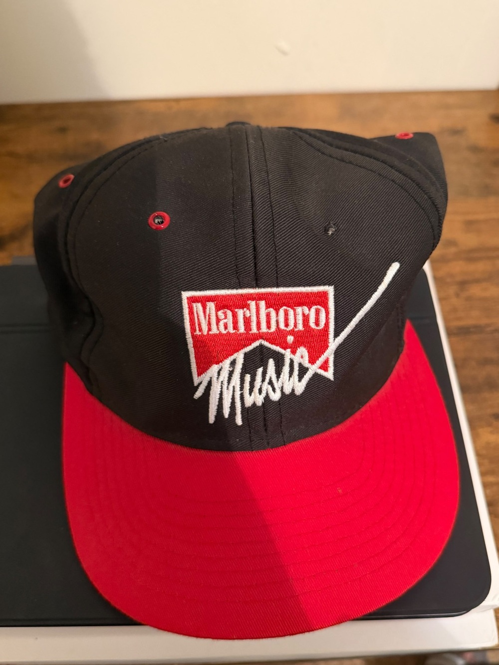 This item is a promotional snapback hat from the 1990s (circa 1990–1996) produce